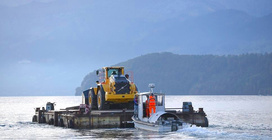 VOLVO CE FLOATS L260H ACROSS SWISS LAKE TO CUSTOMER QUARRY